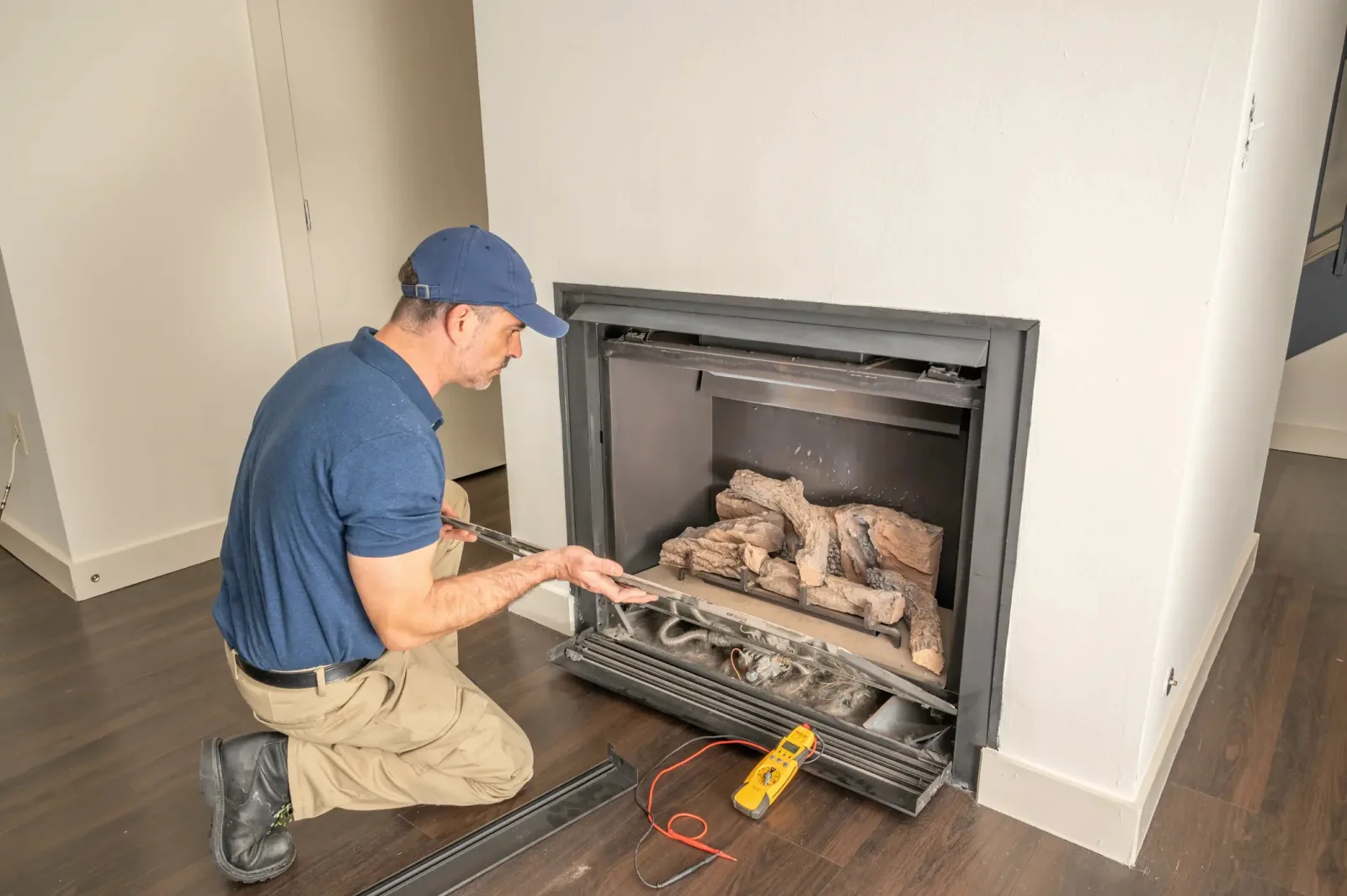 Inspector examining gas fireplace connections